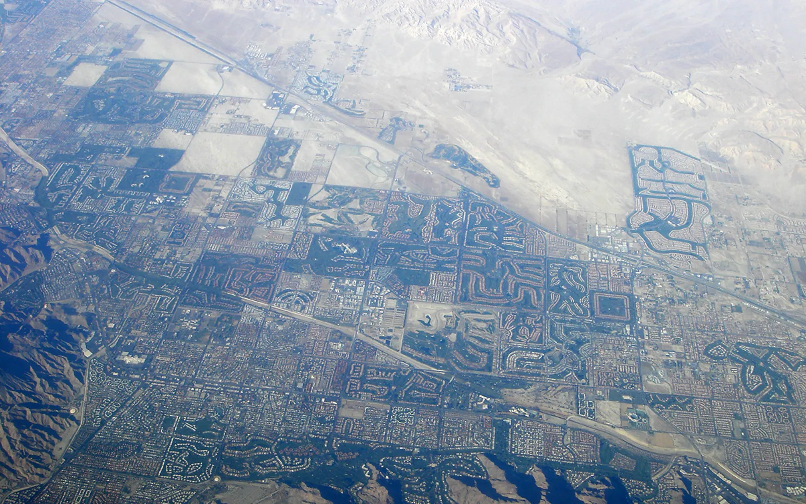 Desert valley landscape showing developed areas and natural desert terrain characteristic of resort communities